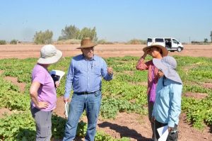 Jim speaks to a group in the melon field