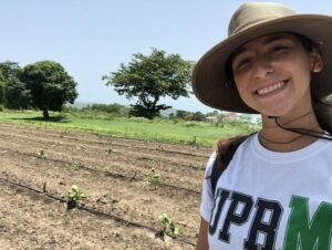 andrea next to a squash field