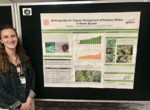 Libby standing next to her poster